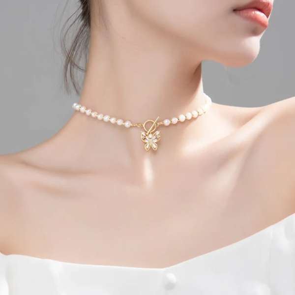 Model wearing Butterfly Bliss Freshwater Pearl Necklace with freshwater pearls and butterfly charm