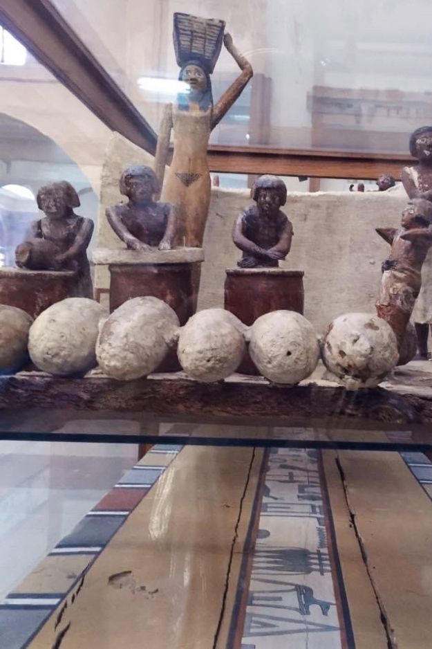 Ancient Egyptian artifacts on display at the Cairo Museum, showcasing detailed sculptures and historical craftsmanship.