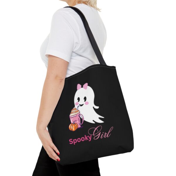 Women wearing a spooky girl tote bag. Design has a cute ghost sipping from cup