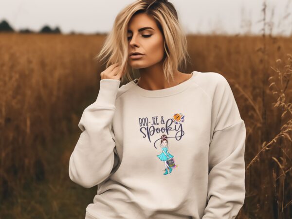 A model wearing our sandstone 'Boojee and Spooky' Halloween sweatshirt with a chic pumpkin and spooky girl design.