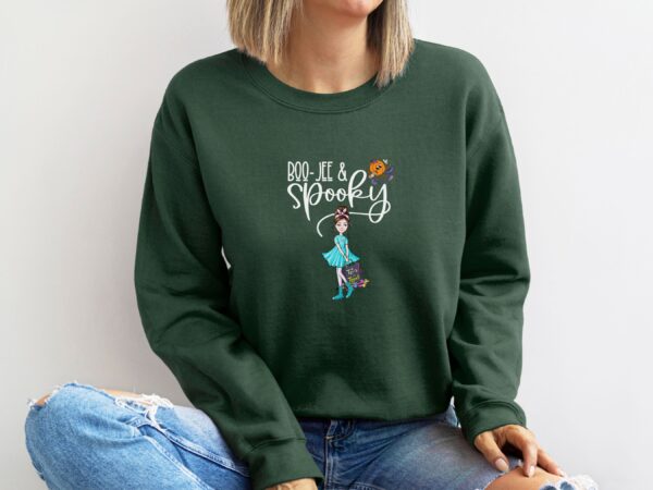 A model wearing our forest green 'Boojee and Spooky' Halloween sweatshirt with a chic pumpkin and spooky girl design.
