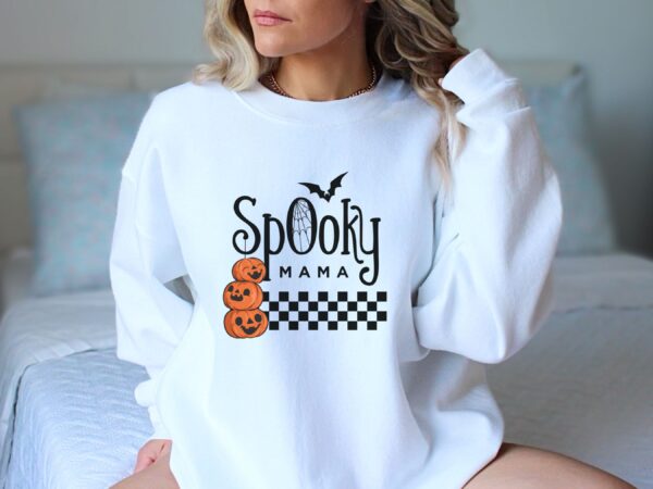 A White "Spooky Mama" Sweatshirt adorned with a pumpkin design, perfect for those who love purity in style.