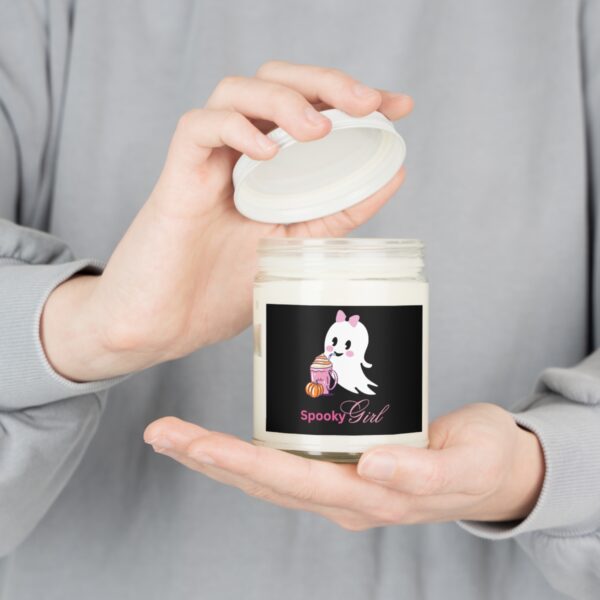 Whimsical Halloween candle with a cute ghost illustration.