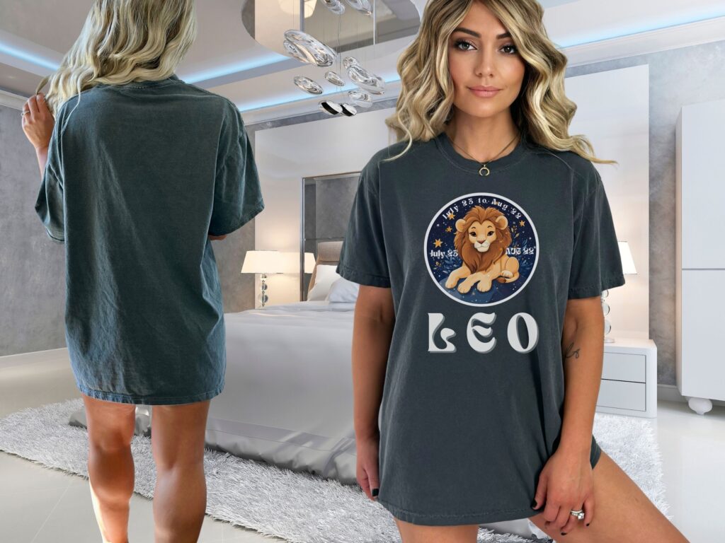 Woman wearing a Pepper Comfort Colors 1717 t-shirt with a Leo Zodiac design featuring a cute lion illustration, stars, and the dates "July 23 to Aug 22."