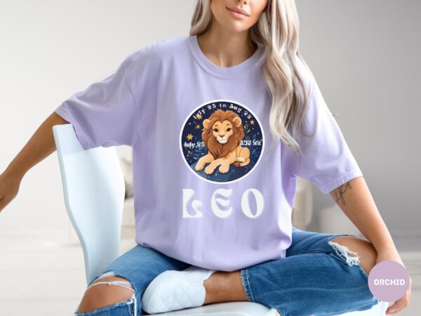 Woman wearing an Orchid Comfort Colors 1717 t-shirt with a Leo Zodiac design featuring a cute lion illustration, stars, and the dates "July 23 to Aug 22."