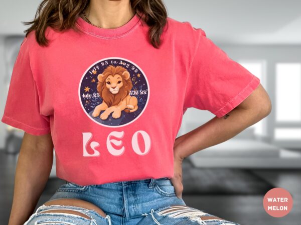Woman wearing a Watermelon Comfort Colors 1717 t-shirt with a Leo Zodiac design featuring a cute lion illustration, stars, and the dates "July 23 to Aug 22."