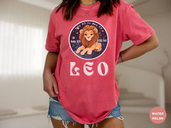 Woman wearing a Watermelon Comfort Colors 1717 t-shirt with a Leo Zodiac design featuring a cute lion illustration, stars, and the dates "July 23 to Aug 22."