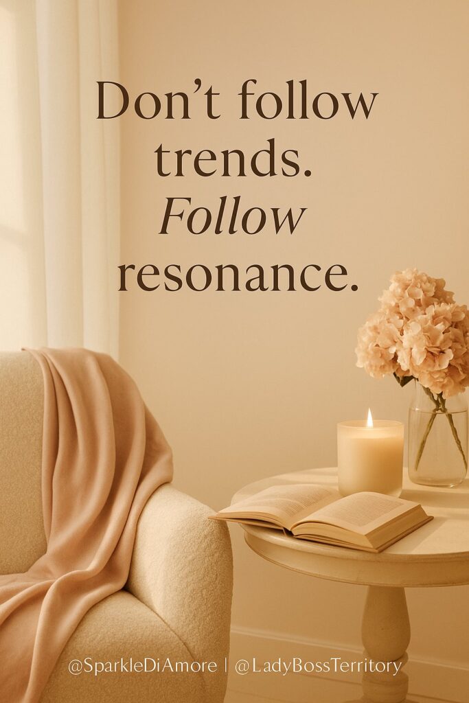Warm, elegant reading nook with blush throw, glowing candle, and open book beneath the quote “Don’t follow trends. Follow resonance.”